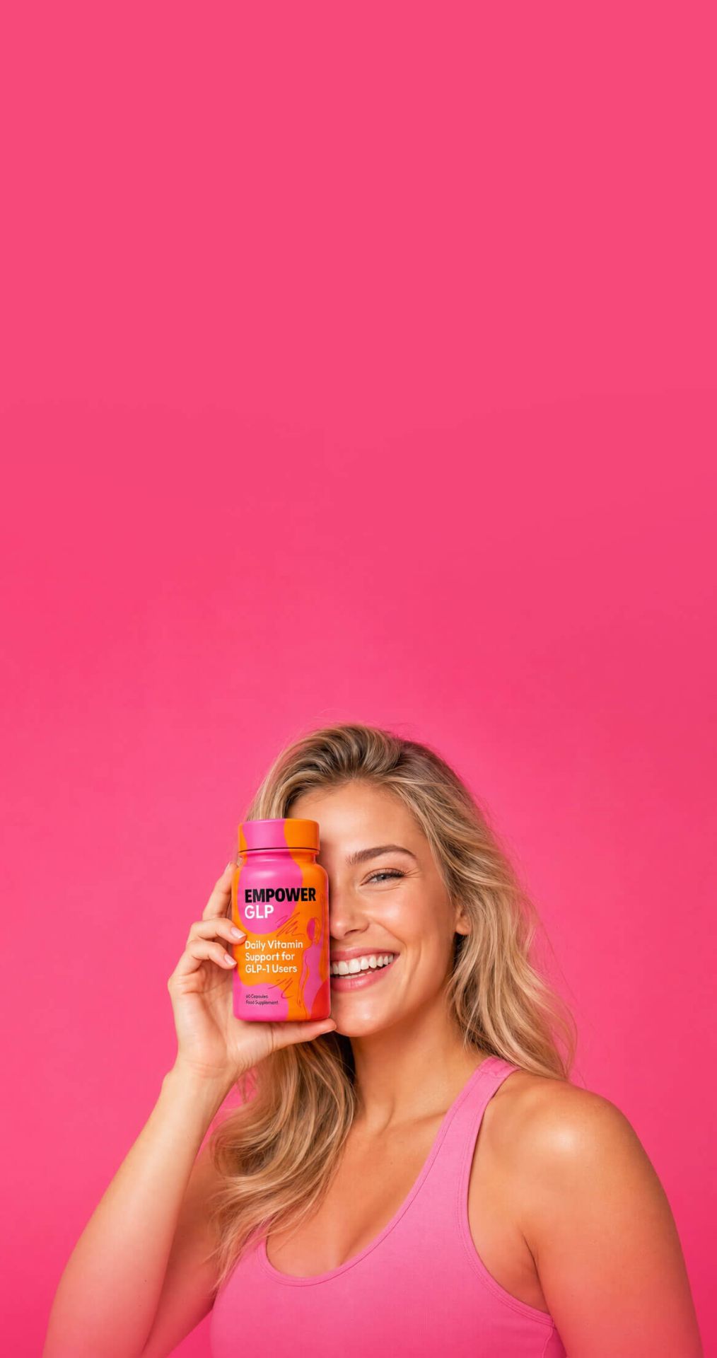 Smiling woman holding an Empower GLP bottle against a pink background