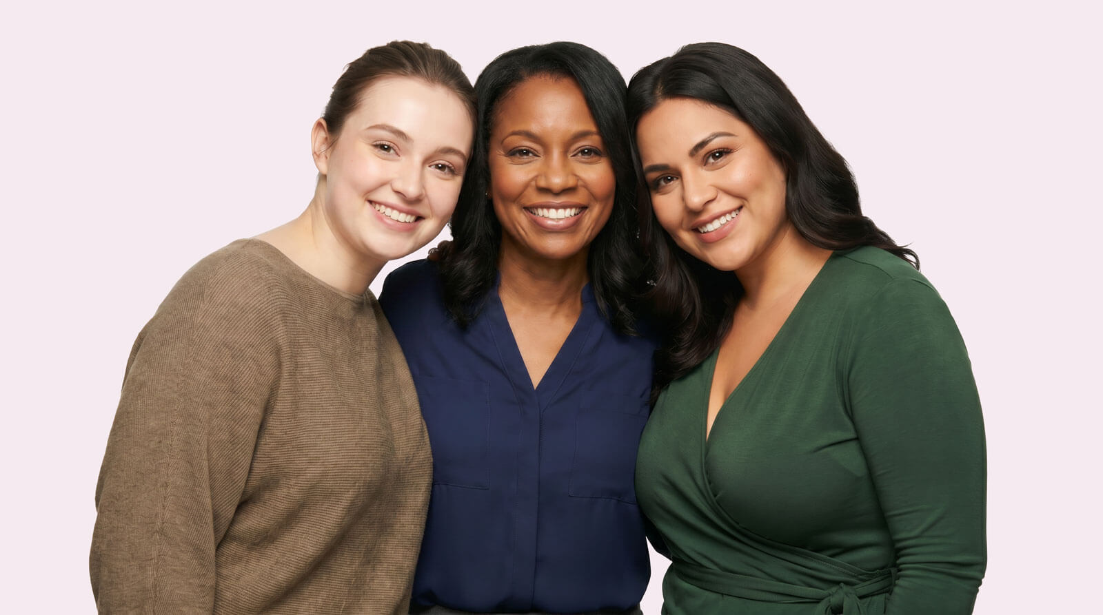Three happy, smiling women standing together