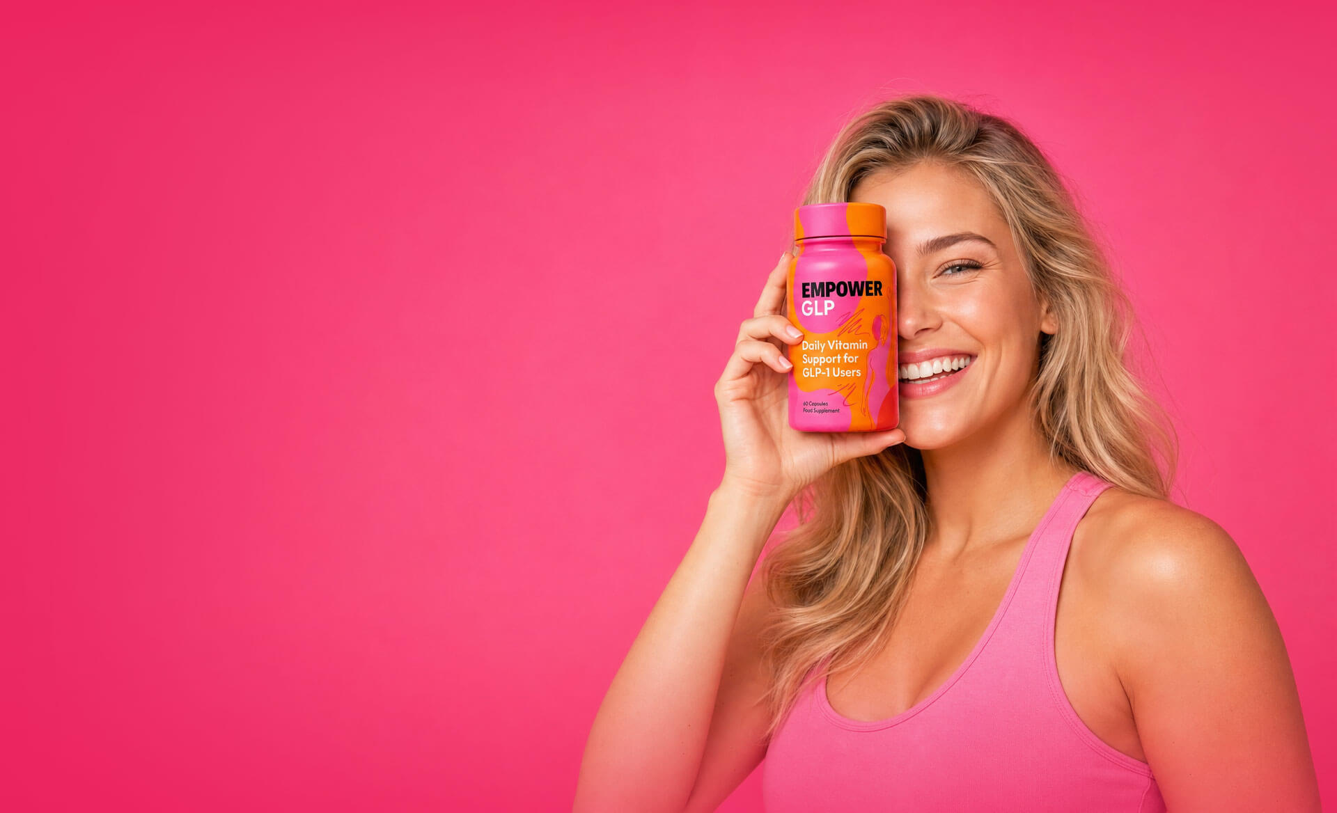 Smiling woman holding an Empower GLP bottle against a pink background
